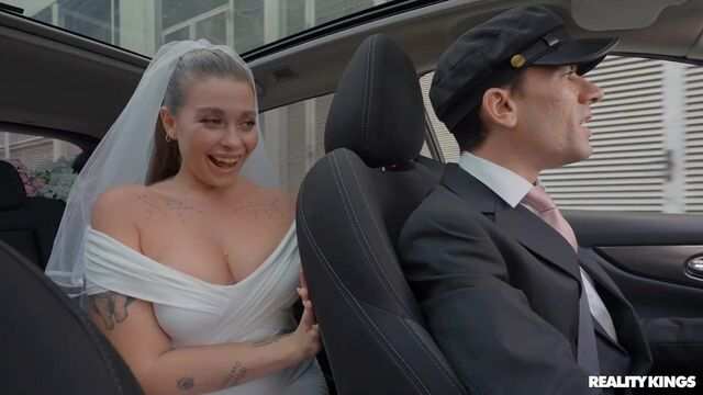 Lustful bride in a wedding dress gives a blowjob to the driver in the car